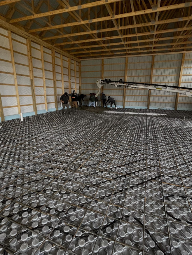 Concrete pour over radiant floor heating system installation by Rochester Remodeling and Home Builders in Rochester, NY.