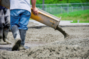 A worker pouring fresh concrete for a job by Concrete Repair Contractor Las Vegas NV.