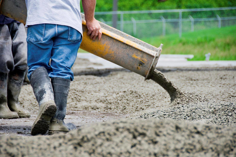 A worker pouring fresh concrete for a job by Concrete Repair Contractor Las Vegas NV.