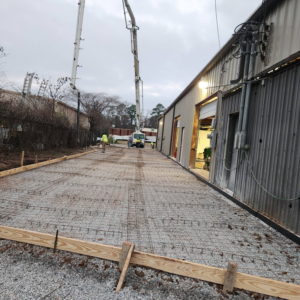 A concrete pump truck pouring a new slab for Unified Services & Sales LLC in Pelham, AL
