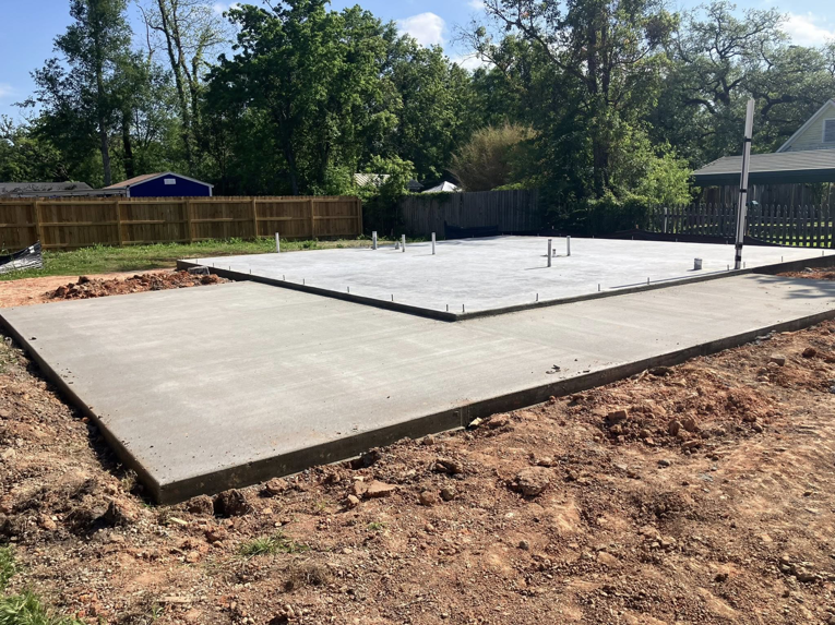 A newly poured concrete slab foundation for a home service project by Comeaux Home Services in Baton Rouge, LA.