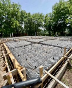 A concrete slab foundation with rebar grid and formwork ready for pouring by Beyond Builders in Tampa, FL