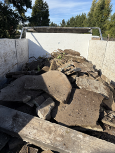 A truck bed filled with broken concrete slabs and demolition debris for hauling by HB Junk Hauling LLC in Springfield, OR.