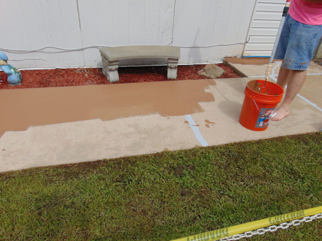 Applying a protective coating to a concrete walkway by E.S. Leonard Waterproofing in De Soto, MO.