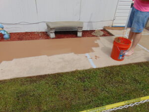 Applying a protective coating to a concrete walkway by E.S. Leonard Waterproofing in De Soto, MO.