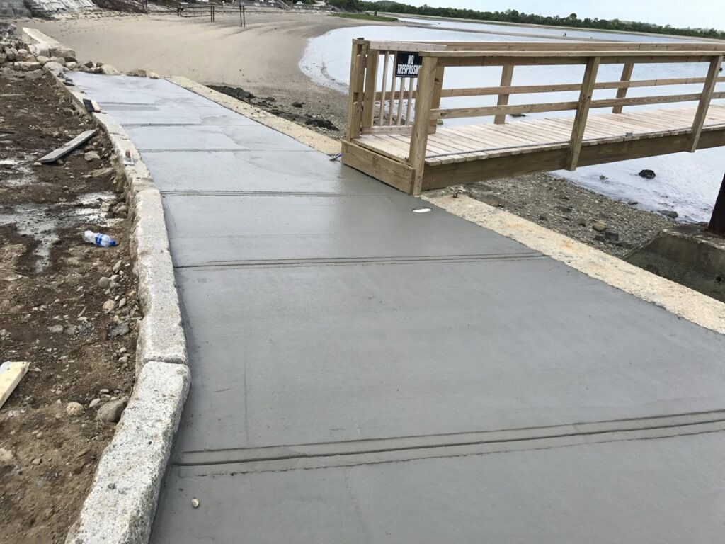 A newly poured concrete ramp leading to a waterfront area by Solimini Excavation and Utility in Freetown, MA