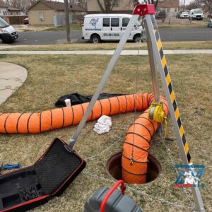 Confined space entry equipment set up over a manhole for sewer work by Top-Notch Plumbing, Heating & Air in Greeley, CO.
