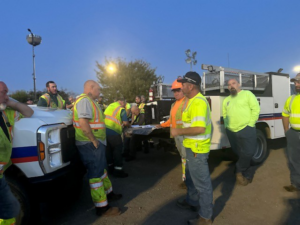 A construction crew in high-visibility gear having a briefing on a job site for Northeast-Paving in Bangor, ME