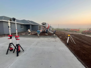 A construction crew pouring concrete for a new home's driveway and foundation by Cogdill Builders of Florida in Tampa, FL.