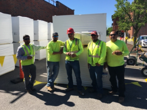 A construction crew with materials on a job site by Active Roofing Company in Chicago, IL