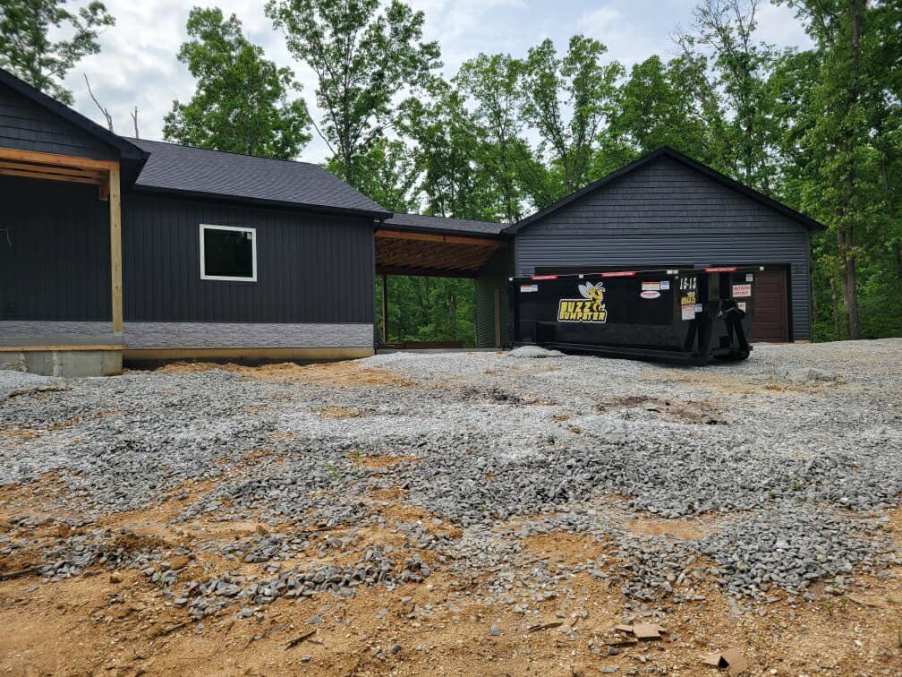 A Buzz Dumpster & Junk Removal container at a construction site for debris removal in Troy, MO.