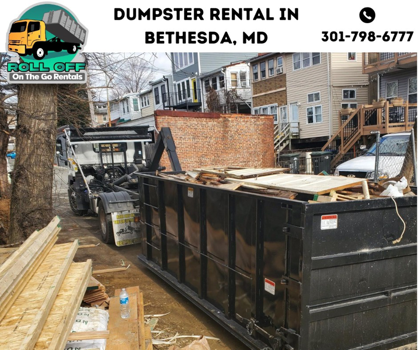 A roll-off dumpster filled with construction debris being picked up by Roll Off On the Go Rentals in Silver Spring, MD.