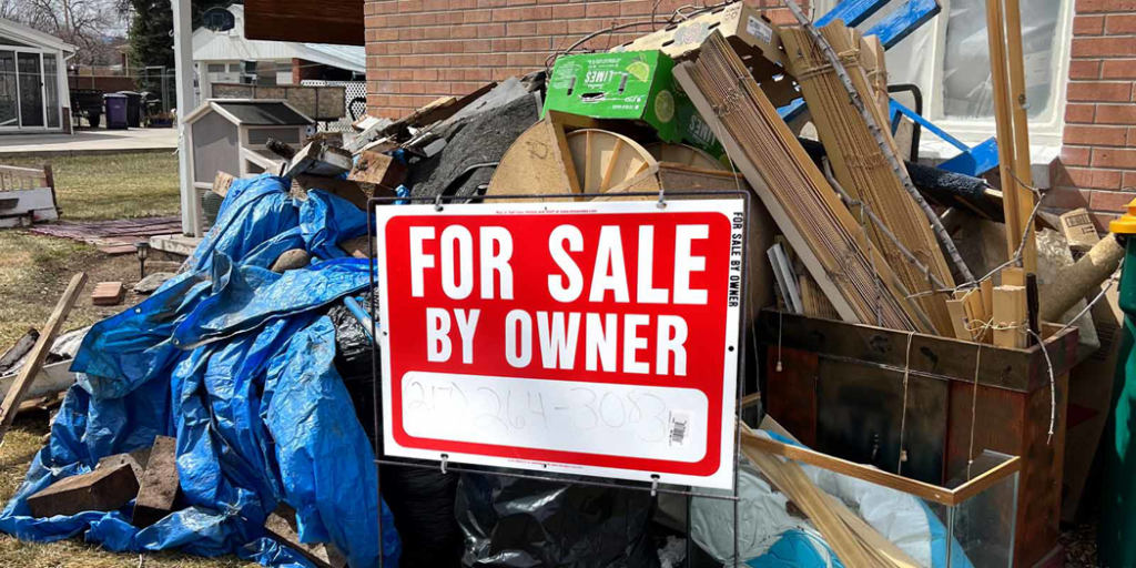 A large pile of construction debris and household junk outside a house, ready for removal by Super Junkers in Denver, CO