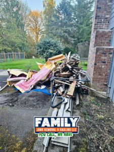 A large pile of construction debris and wood scraps next to a house, ready for removal by Family Junk Removal and Hauling LLC in Seattle, WA
