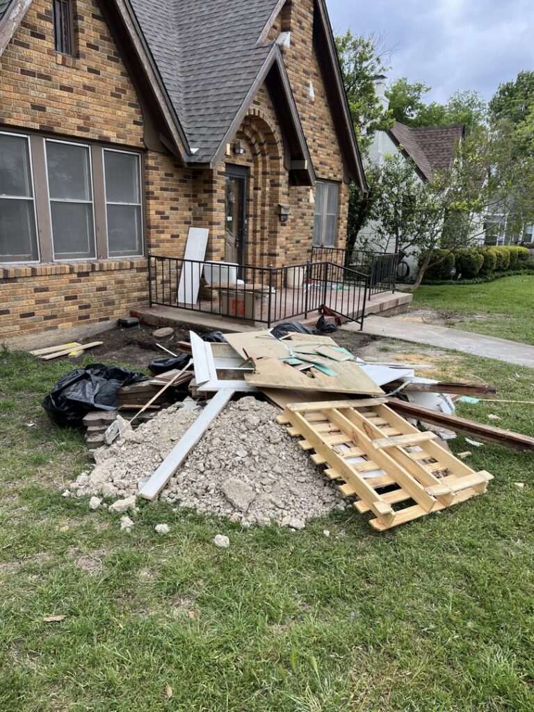 A pile of construction debris and general junk outside a residential home, awaiting removal by NTX Haul Away Junk Removal in Fort Worth, TX.