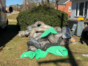 A large pile of construction debris, including old HVAC ducts, ready for removal by Junkslingers NC in Cary, NC.