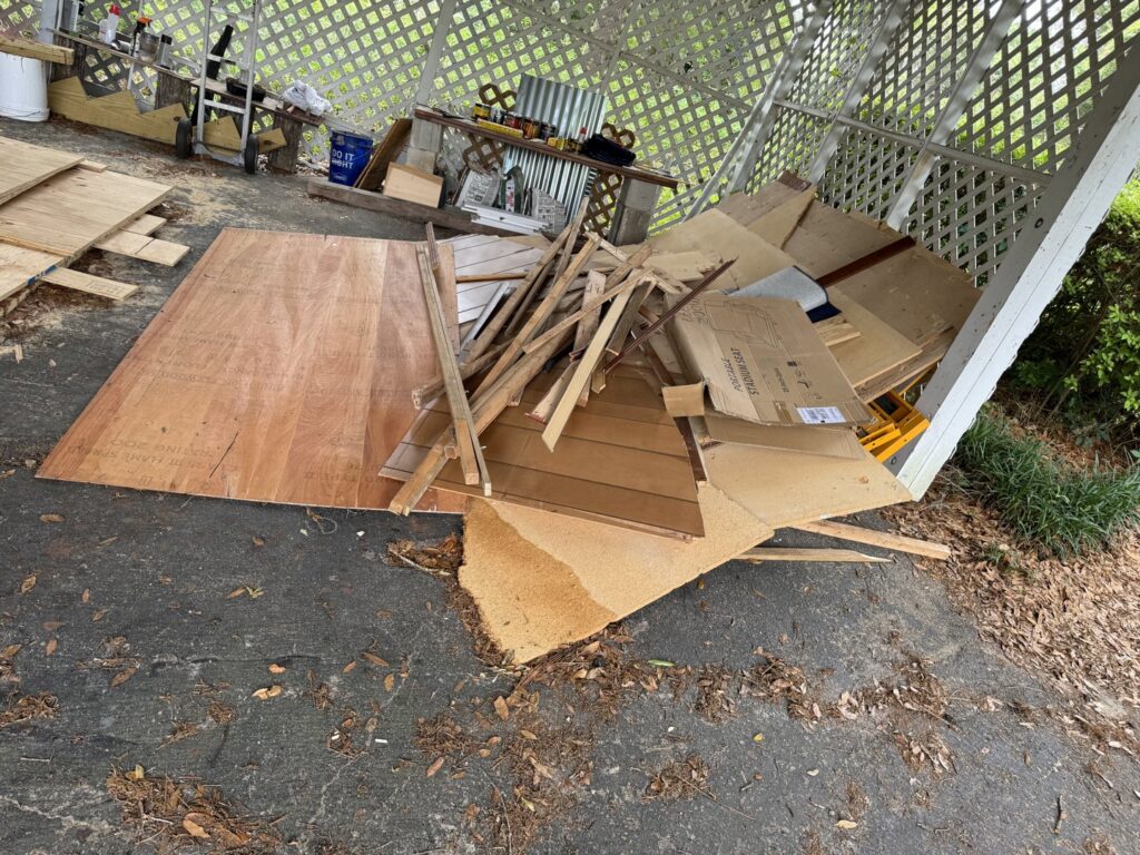 A large pile of construction and renovation debris, including wood and cardboard, ready for removal by L.P.Z Trash & Junk Removal in Tallahassee, FL.