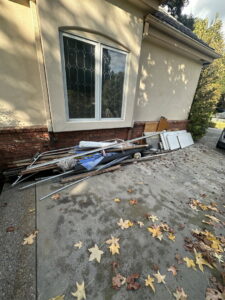 A pile of construction debris, including metal poles and wood, ready for New Haul Junk Removal in Los Angeles, CA.
