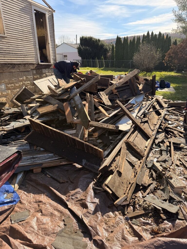 A large pile of construction debris and wood scraps being prepared for removal by Just Junk It in Lancaster, PA.