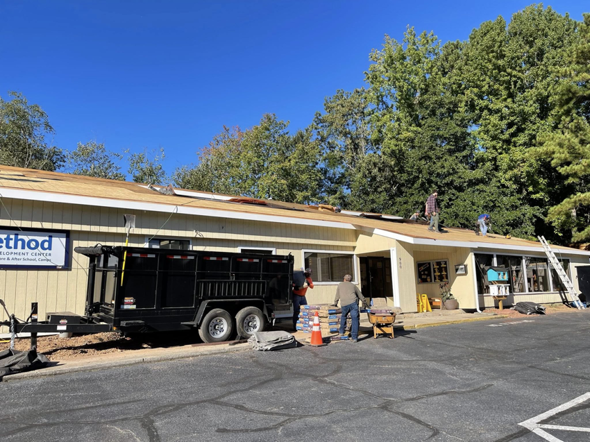 A dump trailer from The Dump Bros LLC used for construction debris removal at a job site in Raleigh, NC.