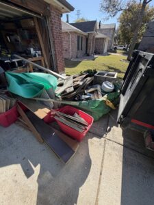 A pile of construction and renovation debris next to a dump trailer, ready for removal by City to City Junk Removal Fort Worth, TX.