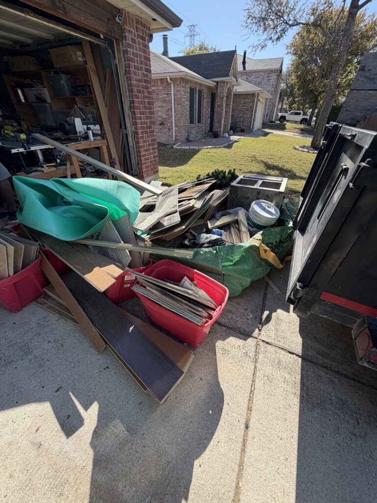 A pile of construction and renovation debris next to a dump trailer, ready for removal by City to City Junk Removal Fort Worth, TX.