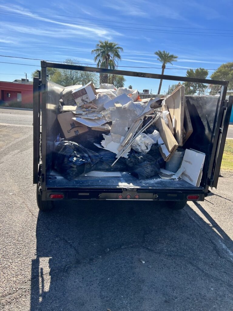 A dump trailer filled with construction debris, showcasing junk removal services by HAVOC Demolition in Scottsdale, AZ.
