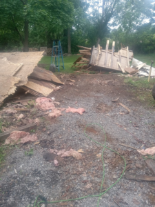 A large pile of construction and demolition debris, including wood and insulation, removed by Cox Junk & Debris Removal in Buffalo, NY.