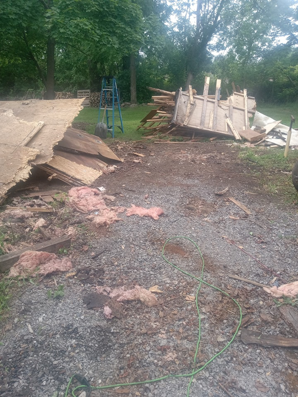 A large pile of construction and demolition debris, including wood and insulation, removed by Cox Junk & Debris Removal in Buffalo, NY.