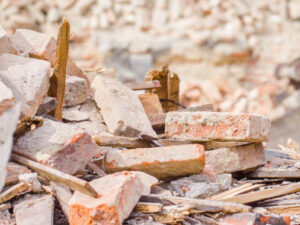 A pile of broken bricks and wood debris from construction or demolition, ready for removal by Trashouts Junk Removal in Pembroke Pines, FL.