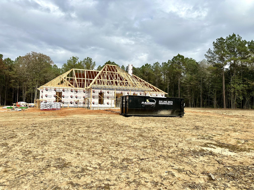 A construction dumpster from Parish Dumpsters, LLC placed at a new home build site in Baton Rouge, LA.