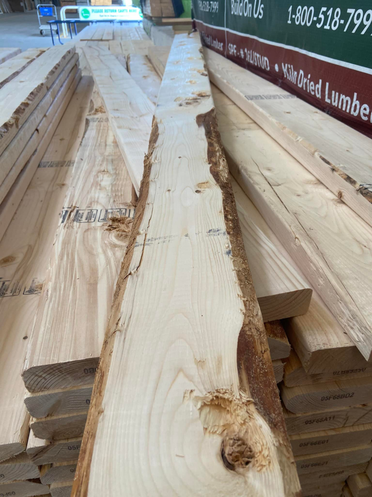 A large stack of construction lumber and building materials for projects by Handy Hubby South Elgin, IL