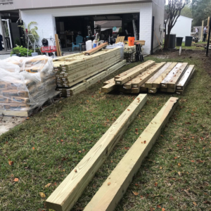 Stacks of lumber and building materials on a job site, ready for Rob the Roofer's construction project in Houston, TX.