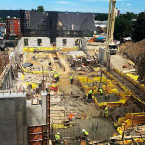 Workers pouring concrete at a large construction site managed by The J. Pilla Group Ltd. in The Bronx, NY.