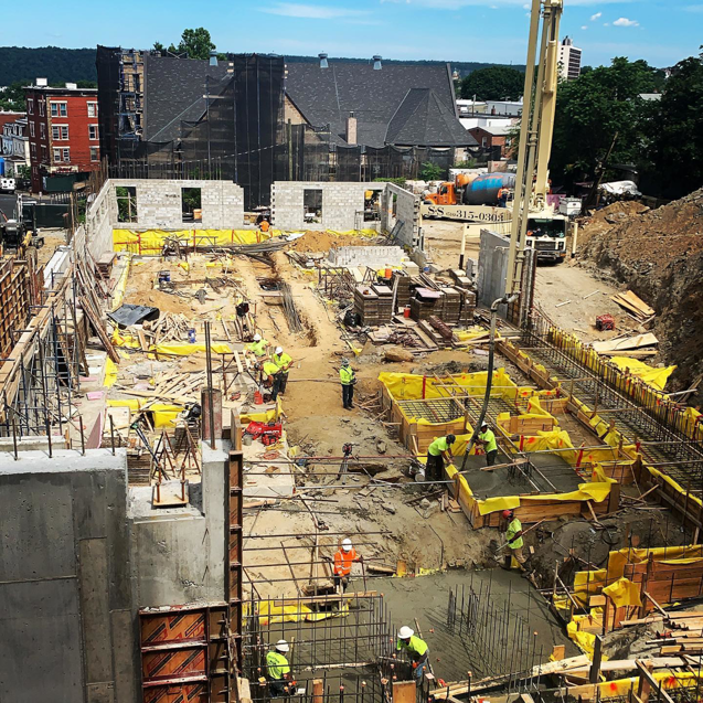 Workers pouring concrete at a large construction site managed by The J. Pilla Group Ltd. in The Bronx, NY.