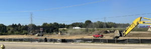A large construction site with earthmoving equipment and a red pickup truck by R A Seaton Contractor Services in Rockford, IL.