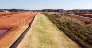 A large construction site with a newly hydroseeded ditch and erosion barriers installed by Tennessee Valley Erosion Control in Huntsville, AL.
