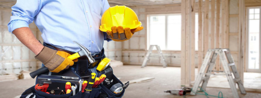 A construction worker with a tool belt and hard hat on a job site, representing Montano's Handyman in Fresno, CA