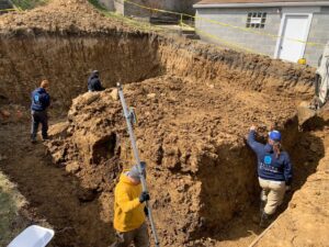 Construction workers performing excavation and site preparation at a job site for 3Rivers General Contracting in Pittsburgh, PA.