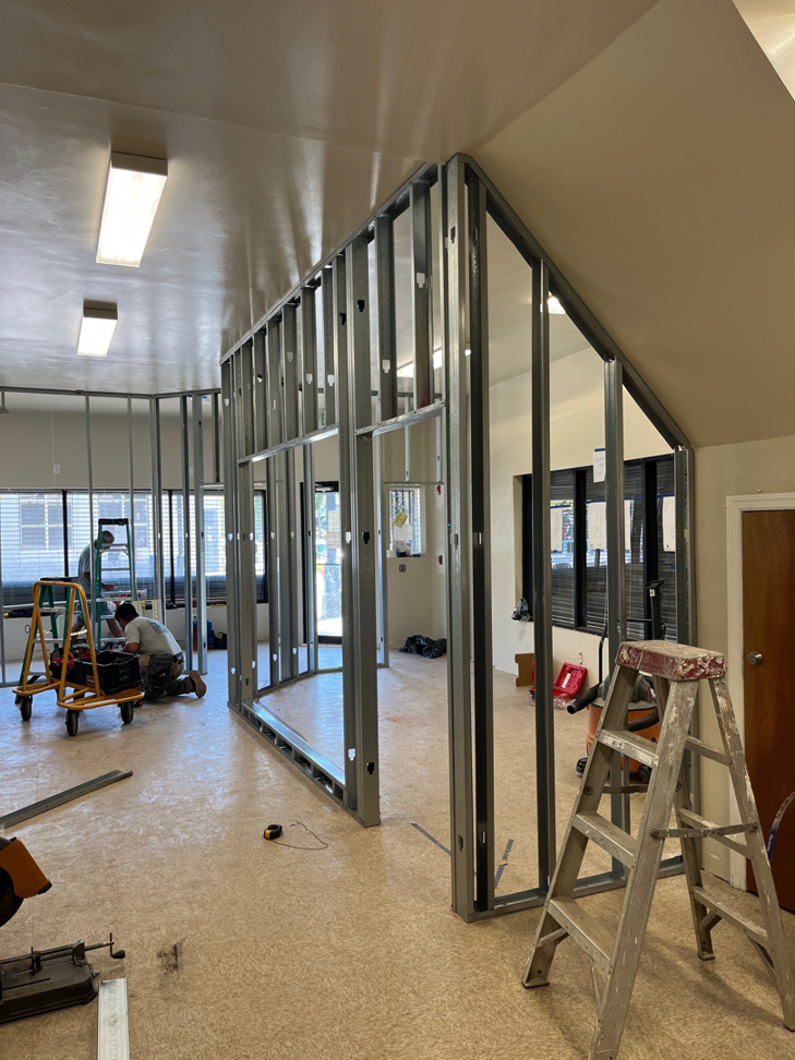 Construction workers framing new interior walls for a commercial space by Pharos Contracting Company Inc. in Newark, NJ