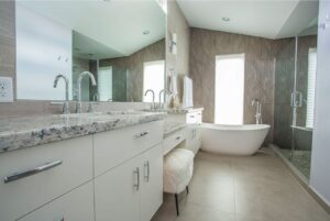 A contemporary bathroom remodel with a freestanding tub and glass shower by All Star Construction, Inc. in Houston, TX.