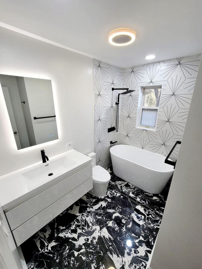 A contemporary bathroom renovation with a sleek freestanding tub and patterned floor tiles by Dr.House in Orlando, FL