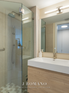 Contemporary bathroom vanity, sink, and mirror installation by J Romano Group in Miami Beach, FL