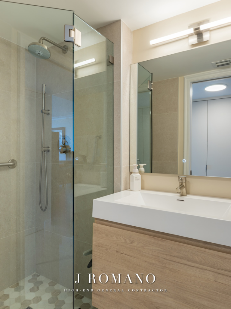 Contemporary bathroom vanity, sink, and mirror installation by J Romano Group in Miami Beach, FL