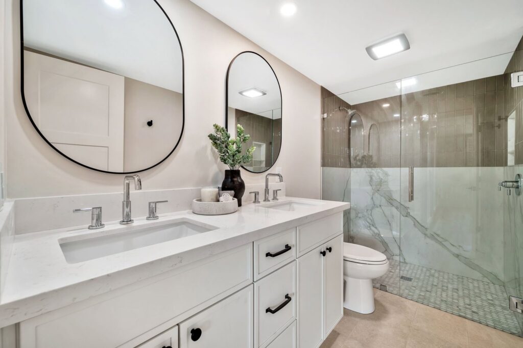 A contemporary bathroom with a double vanity and glass-enclosed shower by AZ New Bath in Glendale, AZ