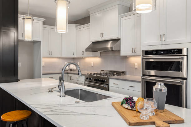 A contemporary kitchen design with white cabinets, stainless steel appliances, and a large island by North Shore Kitchens in Pittsburgh, PA.