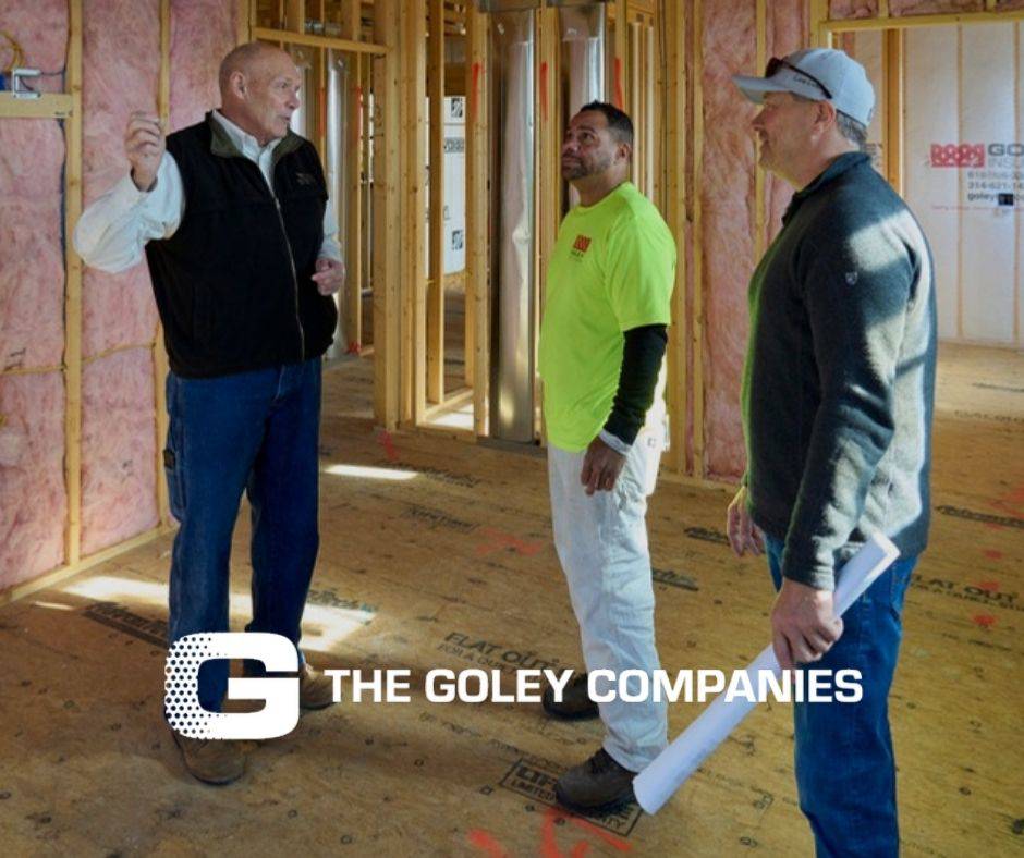 General contractors discussing a project on a construction site with framing and insulation by Prairie Insulation LLC in Springfield, IL.