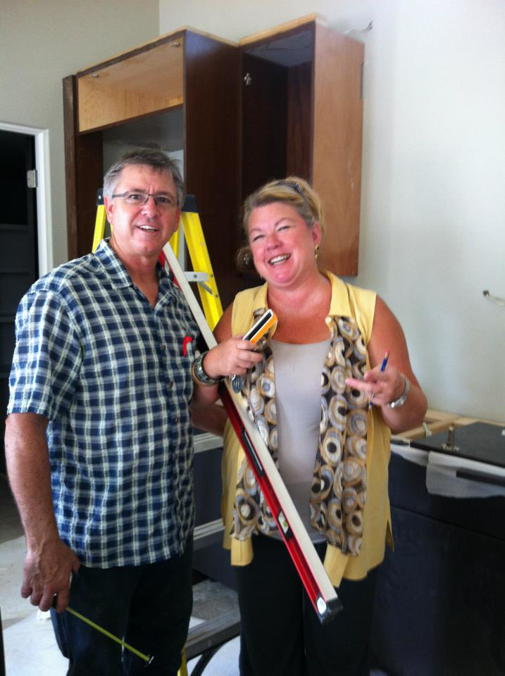 General contractors inspecting newly installed kitchen cabinets during a project by Enertech Builders in Austin, TX.