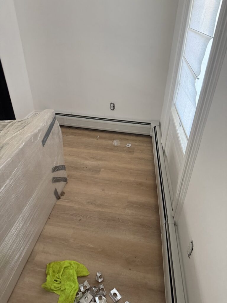 Corner baseboard heating installation in a room with new flooring by Clear Flow Plumbing, Heating, and Hvac Contractors LLC in Jersey City, NJ