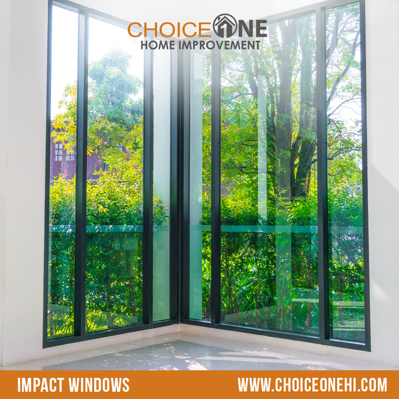 Newly installed corner impact windows offering a view of lush greenery by Choice One in Miami, FL